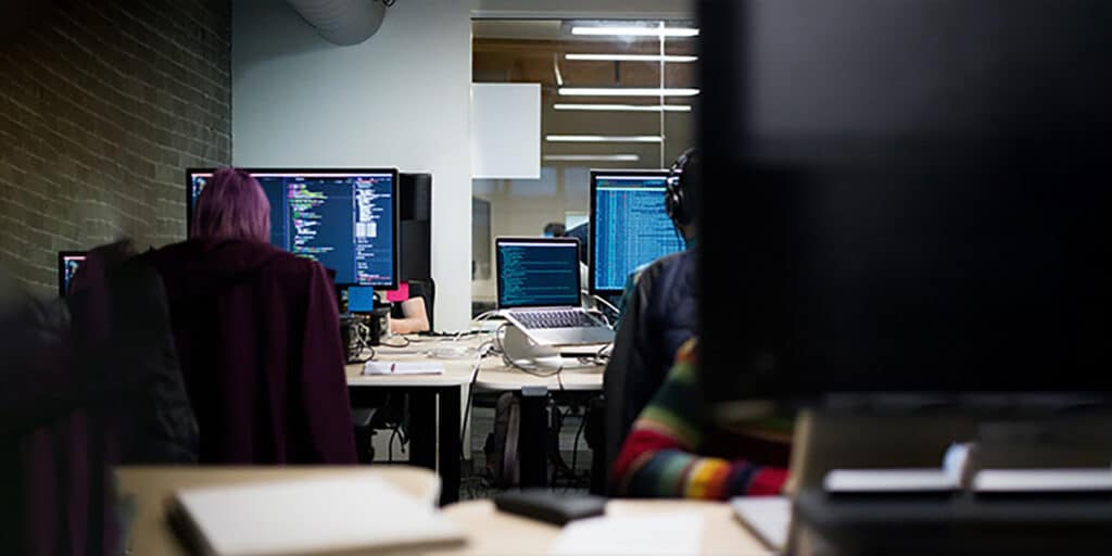 Two SOC 2 certification analysts analyzing and investigating the nature of an incident in an Information Technology (IT) office