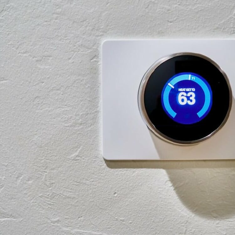 Nest thermostat Internet of Things (IoT) device installed on a wall